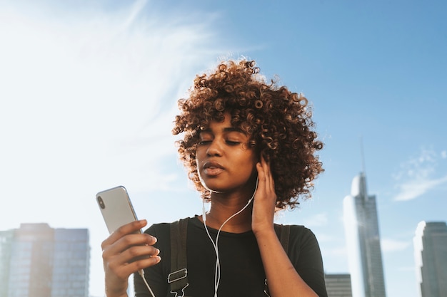 Chica escuchando música desde su teléfono.