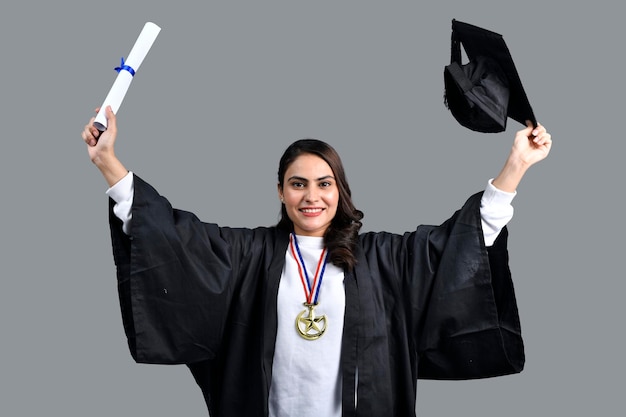 Chica estudiante graduada emocionada sosteniendo diploma en mano modelo paquistaní indio