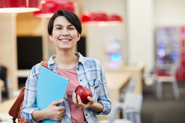 Chica exitosa estudiante con manzana