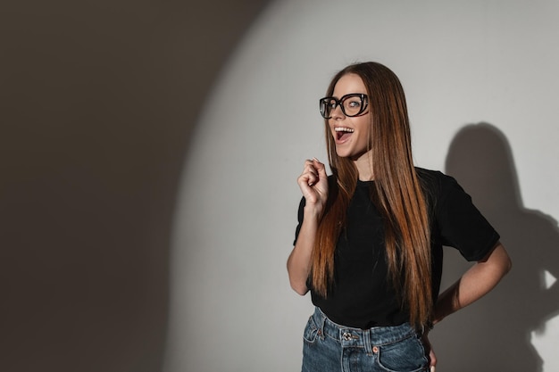 Chica feliz con emociones sorprendidas en estudio Mujer divertida en estudio