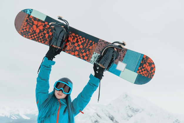 Chica feliz snowboarder al aire libre