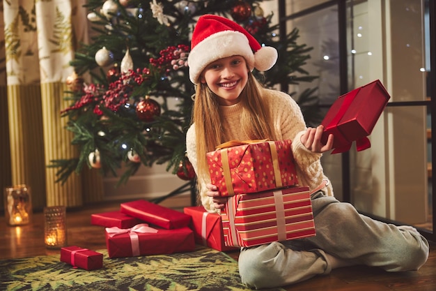 Chica guapa feliz recibiendo regalos en Navidad