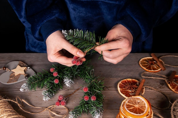 La chica hace decoraciones navideñas vintage en casa celebrando Navidad y Año Nuevo