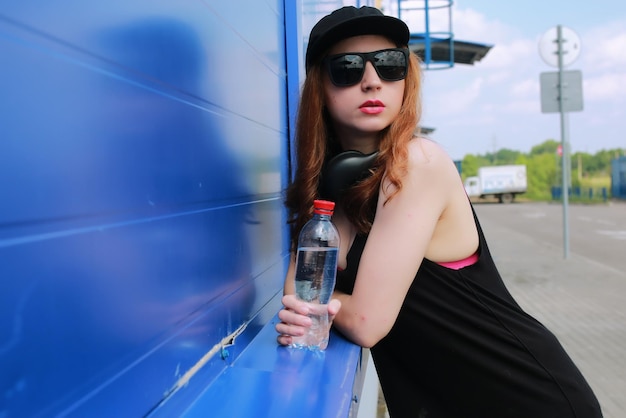 Chica hipster en la pared azul