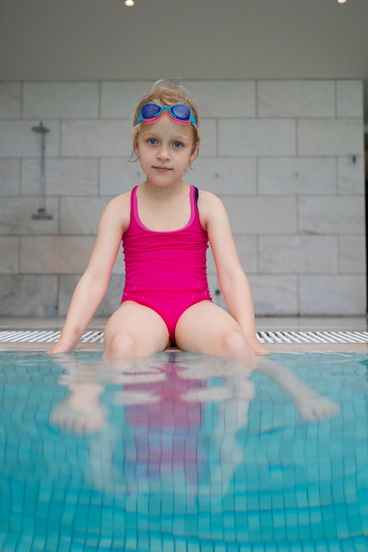 Una chica joven relajándose a la orilla de la piscina
