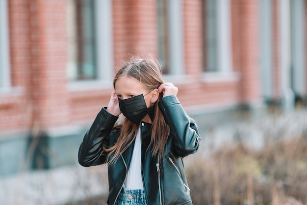 Chica con una máscara protege contra el coronavirus y el agarre