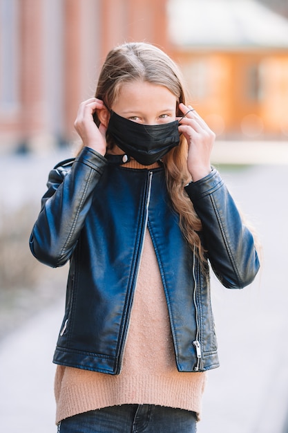 Chica con una máscara protege contra el coronavirus y el agarre