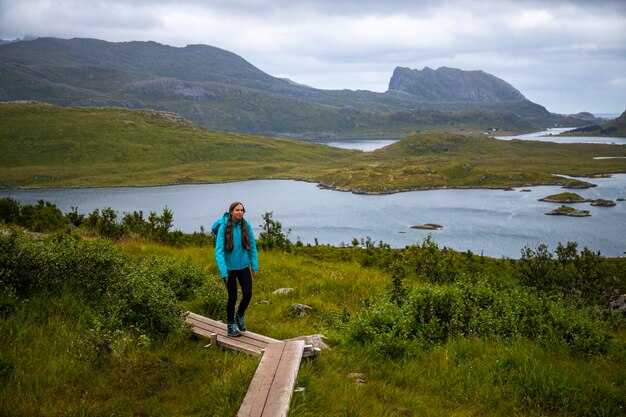 chica con una mochila de excursión a la famosa playa de kvalvika en las islas lofoten, noruega senderismo en noruega