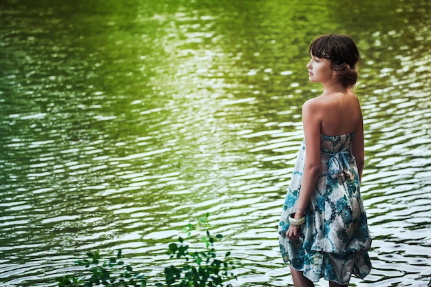 Chica quedándose junto a un lago