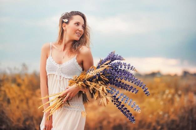 Chica con un ramo de flores en otoño