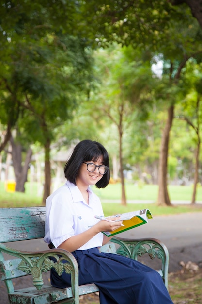 Chica sentada y leyendo un libro.