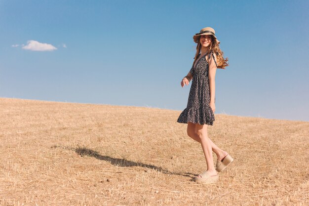 Chica con sombrero en una soleada tarde de verano