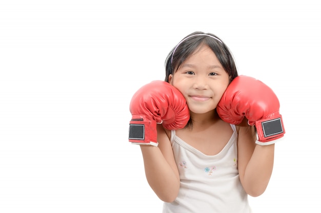 Chica de sonrisa peleando con guantes de boxeo rojos aislados