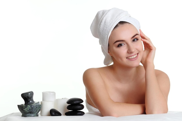 Foto chica en una terapia con piedras masaje con piedras calientes aislado en blanco