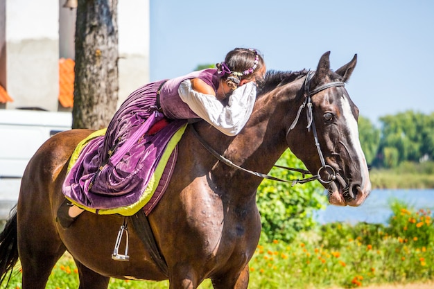 Chica en un traje medieval a caballo