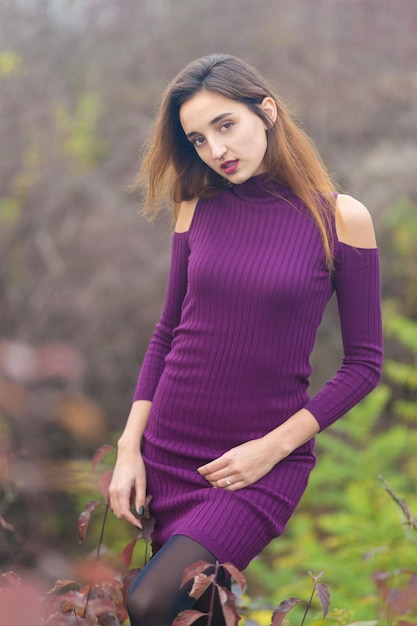 Chica en vestido lila en la naturaleza en otoño Retrato de una hermosa niña en el otoño en el bosque