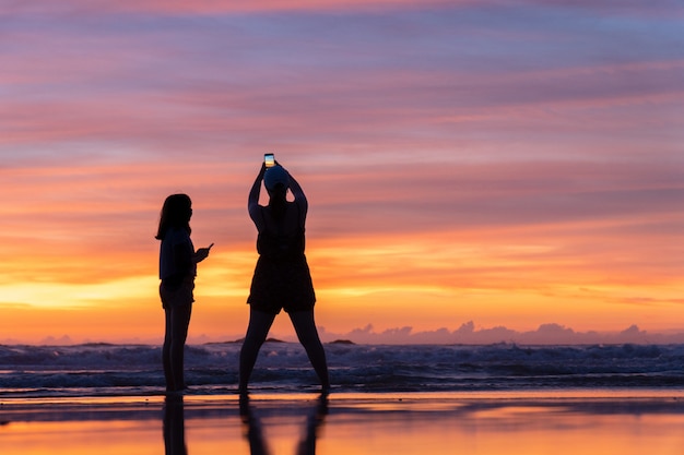 Una chica de viaje relajante en la playa de arena blanca durante el atardecer