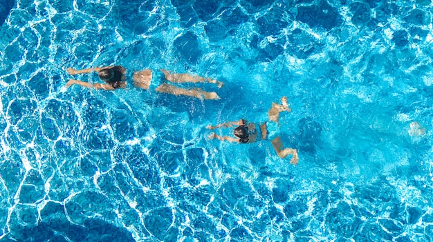 Chicas activas en vista de drone aéreo de agua de piscina