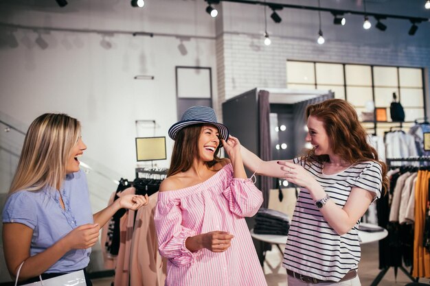 Chicas felices disfrutando del tiempo de compras juntas en la tienda