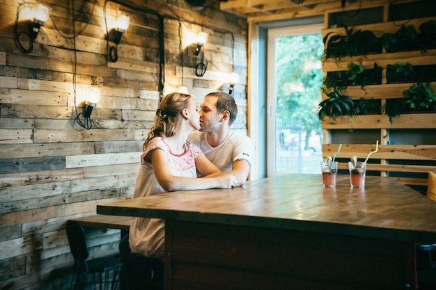 Chico y chica reunidos en un café estilizado de la ciudad