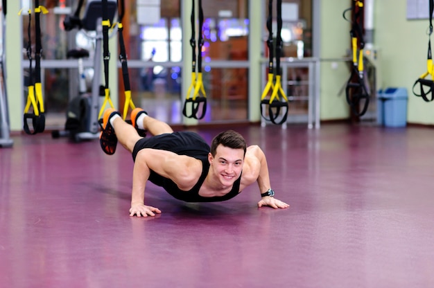 Chico joven se dedica a un pabellón deportivo en el trx