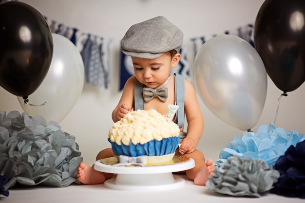 Foto chico lindo de un año sobre un fondo gris