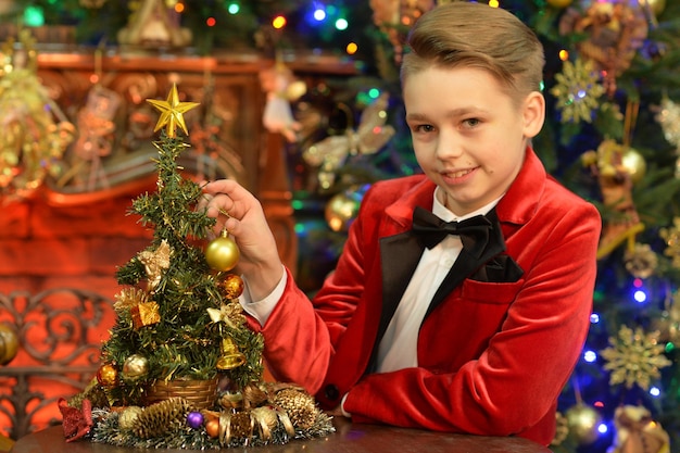 Chico lindo decorar el árbol de Navidad