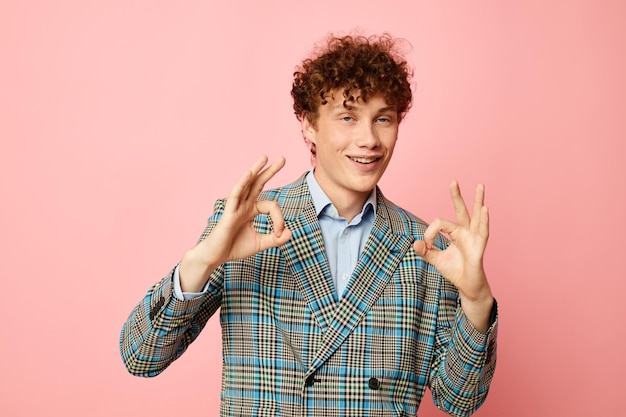 Chico con pelo rizado rojo chaqueta a cuadros estilo elegante posando moda fondo aislado inalterado