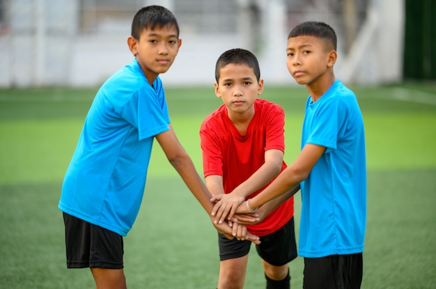 Chicos jugando al fútbol en el campo de práctica de fútbol