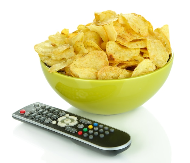 Chips in Schüssel und TV-Fernbedienung isoliert auf weiß