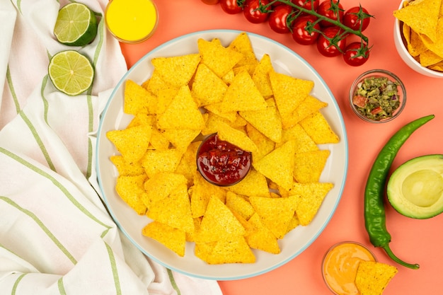 Chips de maíz de nachos mexicanos en un plato con salsa y verduras. Cocina mexicana.