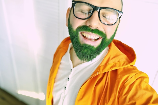 Chocado e feliz feliz dia de são patrício Homem barbudo com olhos bem abertos comemorando o dia de são patrício Hipster com chapéu de duende e fantasia homem irlandês com barba vestindo verde