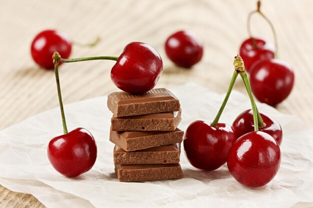 chocolate e cereja em fundo rústico de madeira