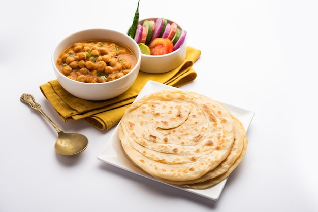 Chole oder Chana Masala mit Paratha, würziges Curry aus Kichererbsen, serviert mit Laccha Parantha. Beliebtes nordindisches Gericht