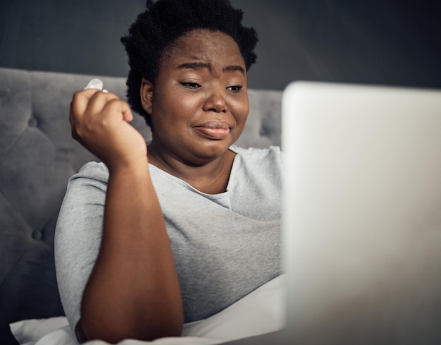 Choro triste e uma mulher negra com um laptop na cama para um filme ou show em uma casa Tecnologia de depressão e uma pessoa africana com um computador para um drama online ou notificação de mídia social