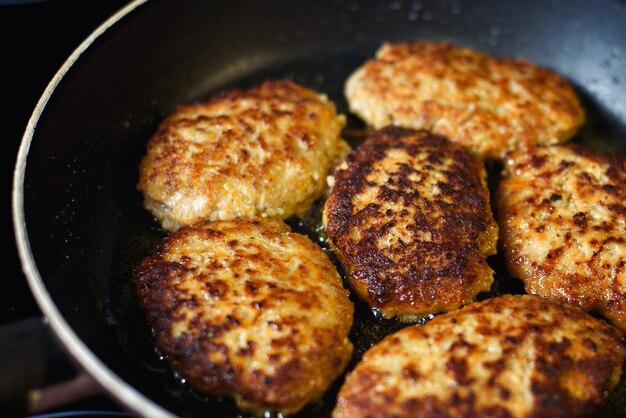 Chuletas fritas en una sartén.