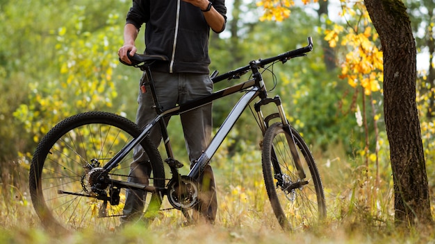 Ciclista de cara na floresta de outono em outubro. Estilo de vida ativo. Atividades ao ar livre e Ciclismo