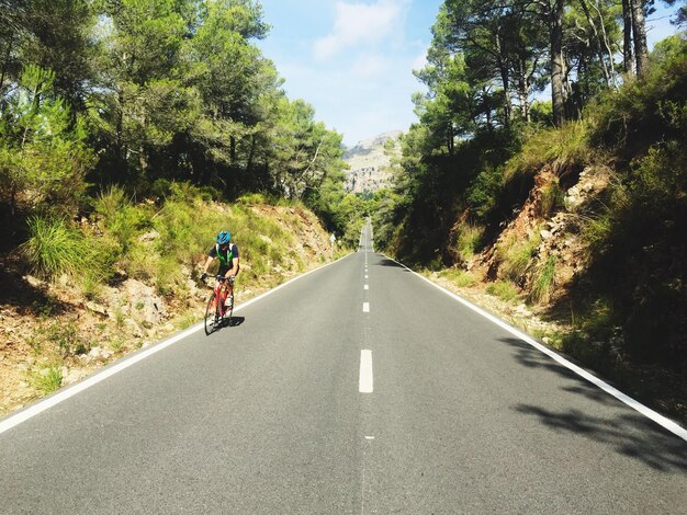 Ciclista montando en la carretera durante un día soleado