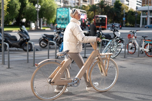 Ciclista mujer caminando cerca del estacionamiento