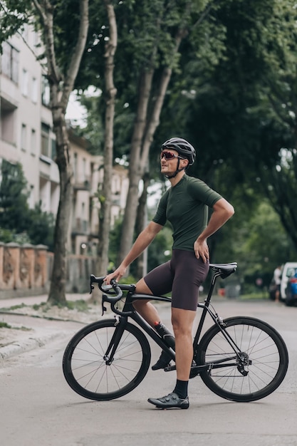 Ciclista profesional descansando en bicicleta después de un paseo por las calles de la ciudad