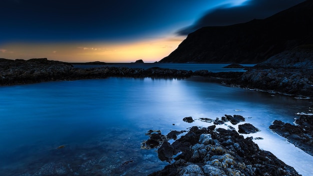 Un cielo azul con una puesta de sol detrás