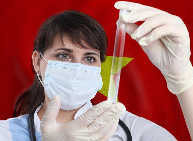 Foto científica con tubo de ensayo coronavirus contra la bandera de vietnam investigación de virus en laboratorio para la prevención de una pandemia en vietnam