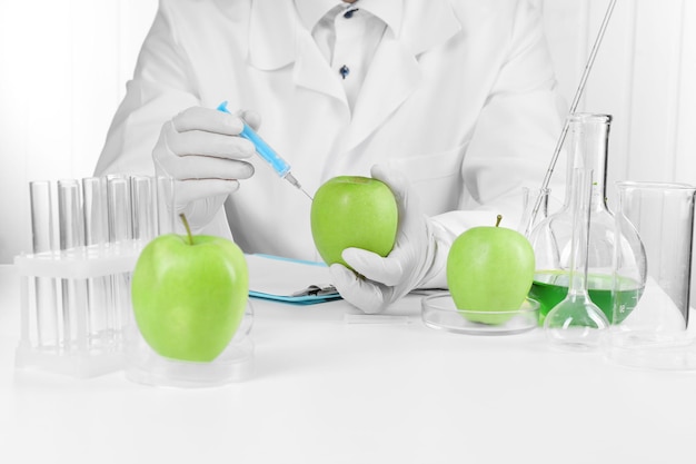 Científico examina manzanas en el laboratorio