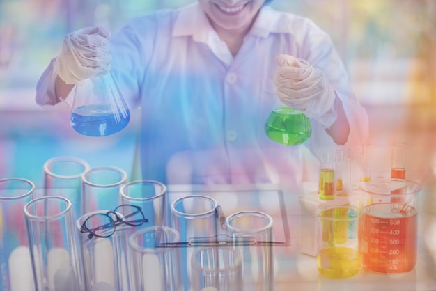 Científico sosteniendo muestras médicas en frascos cónicos en el laboratorio