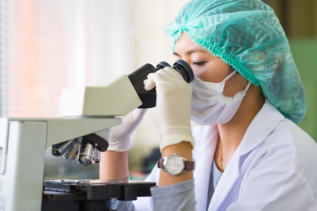 Científico utilizando un microscopio en un laboratorio