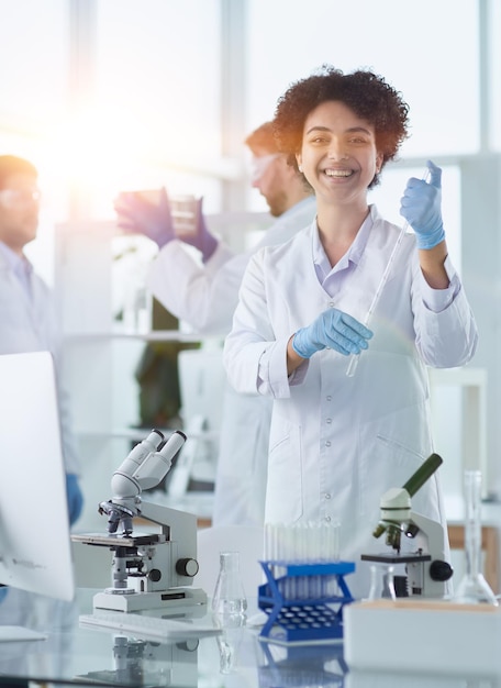 Científicos sonrientes mirando a la cámara con los brazos cruzados en el laboratorio