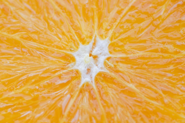 Foto cierre de fruta naranja / textura rebanada fondo naranja