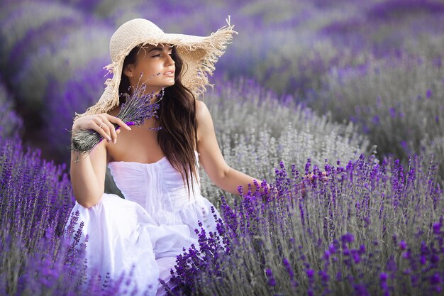 Ciérrese encima del retrato de la mujer joven hermosa en campo de la lavanda.