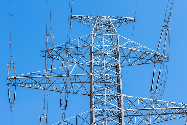 Ciérrese encima de torre eletrical en el cielo azul