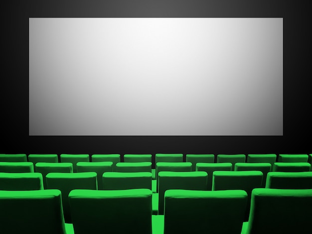 Cine sala de cine con asientos de terciopelo verde y una pantalla en blanco